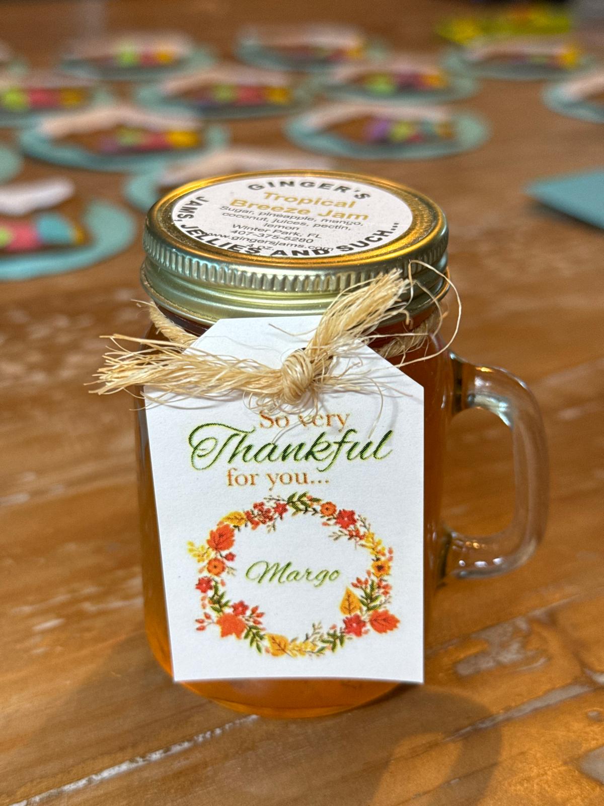A personalized 'So very thankful for you' Ginger's Jams jam favor with a floral tag and raffia tie